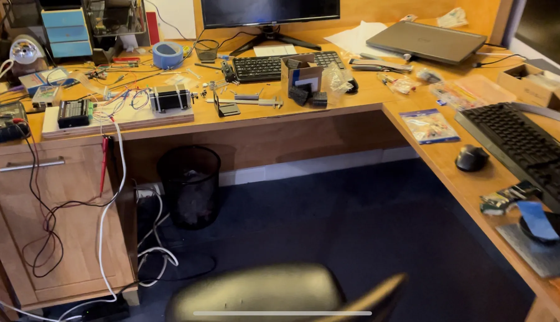 A desk covered in electronics and parts during the motor controller work